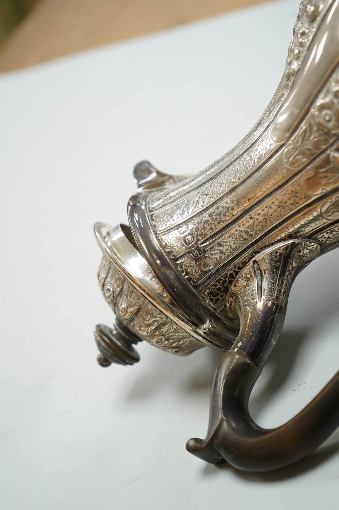A late Victorian embossed silver hot water jug, of baluster form, F.B. Thomas & Co, London, 1892, height 25.5cm, gross weight 18.4oz.